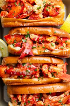 lobster sandwiches with lemon wedges and parsley