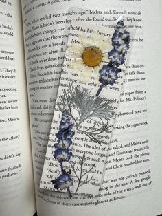 an open book with some flowers on it