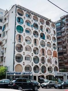 a large building with many circular windows and balconies on it's side