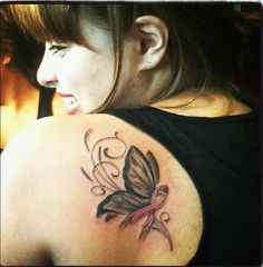 a woman with a butterfly tattoo on her shoulder