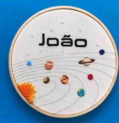 an embroidery project with the word jojo written in black on it, surrounded by planets and sun