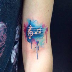 a tattoo with music notes painted on it