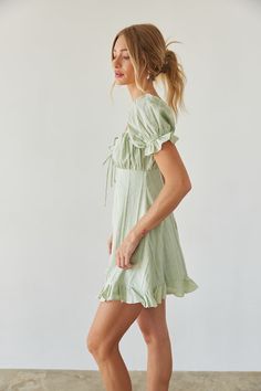 Prepare to blossom in the Clover Puff Sleeve Gingham Mini Dress this Spring Summer! This babydoll mini dress is ready for sunny days and daydreaming; featuring darling puff sleeves, an open back silhouette, tie front bustier detail. Available in white and sage green with a subtle gingham print. Pair this sundress with a pair of cowboy boots to complete the outfit! Details Shell: 100% Cotton Lining:100% Polyester Back zipper and button up closure Elastic sleeves Partially lined Hand Wash Cold Back Silhouette, Gingham Mini Dress, American Threads, Babydoll Mini Dress, Elastic Sleeves, Red Bodycon, Flare Mini Dress, Favorite Sweater, Gingham Print