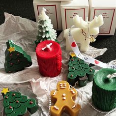 christmas cookies and other holiday treats are laid out on the table with wrapping paper around them