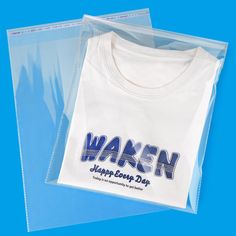 a white shirt with the words waken on it is packaged in clear plastic bags