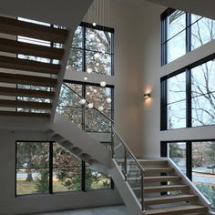 an open floor plan with stairs and windows