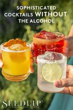 two people holding up glasses filled with alcohol and lemonade, one has a lime slice on the rim