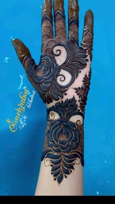 a woman's hand is decorated with hennap and intricate designs on it