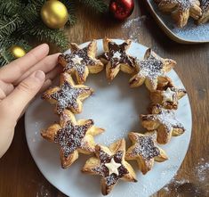 a person is holding a star shaped pastry on a plate