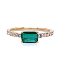 Simple yet vibrant, this emerald ring is the trendy style your jewelry collection needs. The enchanting May birthstone is nestled between pave diamonds (0.19ctw). Crafted from 14K yellow gold, this ring is unique as the emerald is set east to west. Emerald Cut Emerald Ring, Diamond Cuff Bracelet, Pearl Bracelet Gold, Emerald And Diamond Ring, Gold Rings Stackable, Diamond Fashion Rings, May Birthstone, Sterling Silver Hoop Earrings, Sterling Silver Necklace Pendants