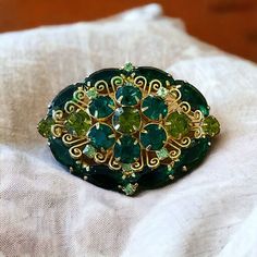 Stunning Verified Juliana Delizza And Elster Green Domed Oval Shaped Brooch With Colors Of Dark Emerald And Peridot Pale Green And Emerald Green Crystal Chaton And Navette Cut Rhinestones And Gold Plated Prong Settings With A Filigree Design. Verified Via Is It Juliana Website Reference Number 6072. Would Be A Beautiful Gift For A May Birthday. As With Any Vintage Or Preowned Item, One Should Expect A Scuff Or Light Scratch Here And There, Or Other Reasonable Signs Of Use Over Time. Sometimes A Green Filigree Brooches As Gift, Oval Green Brooch Jewelry, Elegant Green Gemstone Brooch, Emerald Green Crystal, Antique Green Gemstone Brooches, Juliana Jewelry, Vintage Green Rhinestone Brooches, May Birthday, Green Oval