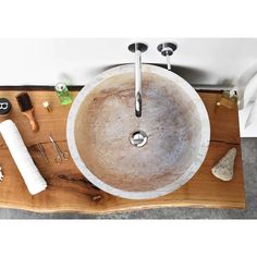 a bathroom sink sitting on top of a wooden counter