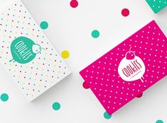 three different colored boxes with polka dot designs on them, one is for cookies and the other is for donuts