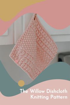 the willow dishcloth knitting pattern is hanging from a hook in front of a kitchen cabinet