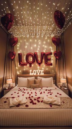 a bed that has some pillows on it and balloons in the shape of hearts above it