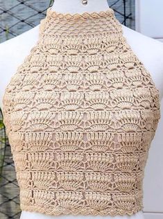 a mannequin wearing a crochet top with an open back and collar