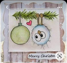 a christmas card with an ornament hanging from a tree