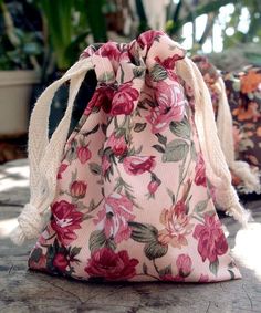 a pink flowered bag sitting on top of a table