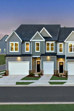 this is an image of a two story house with garages in the front yard