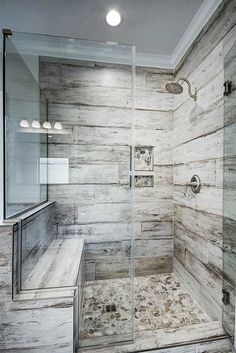 a walk in shower sitting inside of a bathroom