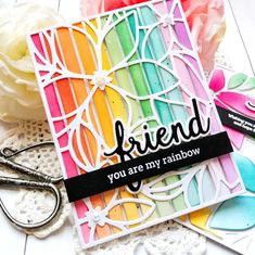 a card with the words, friend you are my rainbow on it and some scissors next to it