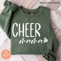 All of our Cheer Mama hoodies are handmade to order on an ultra soft crewneck that will quickly become your go to apparel item! You will never want to take it off! Our Mama sweatshirts are handmade to order with eco-friendly water based ink that feels good and lasts longer! ♥The details♥ This unisex sweatshirt is crafted from soft, breathable fabric for ultimate comfort. Printed with an eco-friendly water-based ink, this sweater not only looks great but also supports sustainable practices. The u Cute Green Sweatshirt For Winter, Cute Green Winter Sweatshirt, Green Pre-shrunk Hoodie With Crew Neck, Green Pre-shrunk Crew Neck Hoodie, Green Crew Neck Sweatshirt With Lettering, Green Long Sleeve Sweatshirt With Lettering, Cute Green Sweatshirt With Letter Print, Cheer Grandma, Cheer Mom Gifts