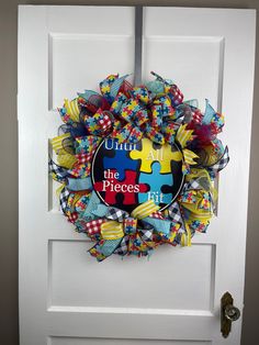 Autism Awareness door wreath, Autism wall decor, Autism door hanger, Until all the pieces fit, child or adult room decor with Blue, Red and Yellow puzzle pieces.  Hang this wreath on your front door, entryway, over your mantle, or maybe you need a gift for a birthday, anniversary, housewarming, wedding, or Christmas gift.  Measurements: 24" H x 24"  W x 7" D Please be sure to use a tape measure if you are unsure of how large or small the size of the wreath measures. Indoor/Outdoor use, but for l Front Door Wreath, Adult Room Decor, Door Wreath Hanger, Front Door Entryway, Door Wreath, Door Entryway, Special Needs, Zip Ties, Tape Measure