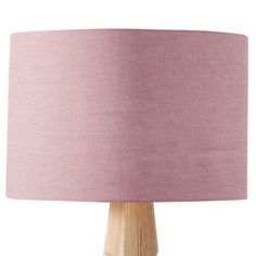 a wooden table lamp with a pink shade on the base and a white light behind it