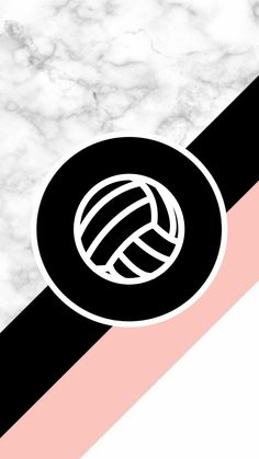 a black and white volleyball ball sitting on top of a pink and black striped wall