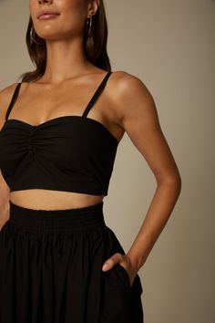 The Daria bralette in black is crafted from Italian organic cotton poplin and features darts, shirring and covered buttons at the front bust. Adjustable spaghetti straps, hook and eye closure and an elasticized back panel enable an easy, comfortable fit. Wear yours with the coordinated Sofia skirt or your favorite pair of jeans. Fit: Bianca, our model is 5.8” or 1.77 m tall and wears size 1. Content: 100% organic cotton poplin. Care instructions: - For easy care, professional wash and fold is re Black Cotton Bra Friendly Crop Top, Black Cotton Crop Top Bra Friendly, Black Cotton Bra-friendly Crop Top, Black Cropped Top With Removable Bra Pads, Black Cropped Tops With Removable Bra Pads, Bra Friendly Black Cotton Crop Top, Chic Black Crop Top With Removable Bra Pads, Fitted Cotton Tops With Removable Bra Pads, Chic Cropped Top With Removable Bra Pads