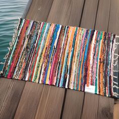 a multicolored rug sitting on top of a wooden dock