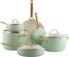 a set of green pots and pans with gold handles