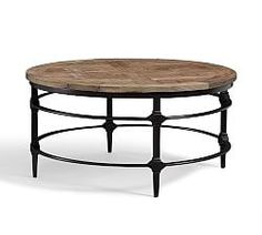 a round wooden table with metal legs on an isolated white background for use as a coffee table