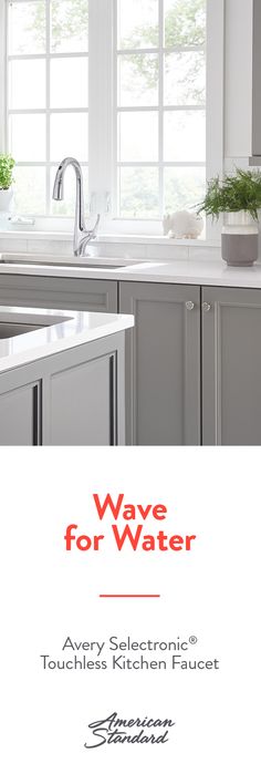 a white kitchen with gray cabinets and an advertisement for wave for water on the window sill