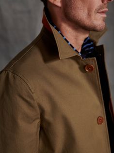 A modern classic, this mid-thigh length jacket is made from organic water repellent cotton from Italy and features a hidden fly front, side tabs, a high collar, and is completely unlined. Hidden details include a contrasting under collar, inner placket, interior yoke lining, and piping. 100% Orgnic Cotton Corozo buttons are harvested from the Tagua Nut in environmentally friendly methods — nature's beauty redefined. As we make every single piece just for you, please allow 10 working days for our Classic Cotton Outerwear With Spread Collar, Classic Gabardine Outerwear With Concealed Front Fastening, Modern Cotton Outerwear With Button Cuffs, Classic Cotton Outerwear With Fold Down Collar, Cotton Outerwear With Concealed Placket And Collar, Cotton Outerwear With Collared Concealed Placket, Business Cotton Outerwear With Spread Collar, Fitted Gabardine Outerwear With Button Cuffs, Long Cotton Coat With Hidden Button Closure