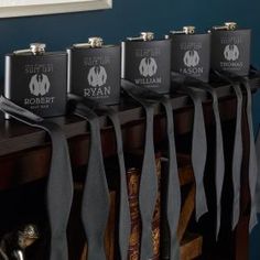 six flasks are lined up on top of a table with black ribbons hanging from them