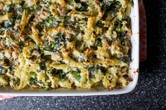 a casserole dish with spinach and cheese