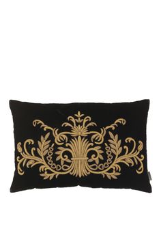 a black and gold embroidered pillow on a white background