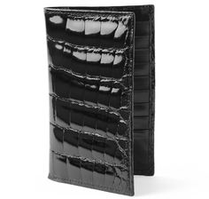 Handcrafted in America from genuine glazed alligator, lined with black calfskin leather, our luxe travel wallet is essential travel accessory. Designed with an interior passport pocket, full length bill or boarding pass compartment, and nine credit card slots. Genuine full grain glazed alligator Rounded and polished edges Interior passport pocket; 9 card slots Full length vertical boarding pass / bill compartment Size: 4" L. x 6-1/2" H. Embossed Sir Jack's logo Handmade in America Luxury Wallets With Crocodile Pattern For Business, Luxury Business Wallets With Crocodile Pattern, Luxury Crocodile Pattern Wallet For Business, Luxury Crocodile Pattern Wallets For Business, Luxury Crocodile Pattern Business Wallets, Luxury Formal Wallet With Crocodile Pattern, Bar Fancy, Black Alligator, Travel Wallet