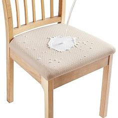 a wooden chair with a white flower on it's seat and the back rest