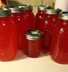 red jars are lined up on the counter