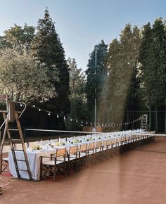 a long table set up for an outdoor dinner