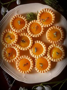 small pies are arranged on a white plate