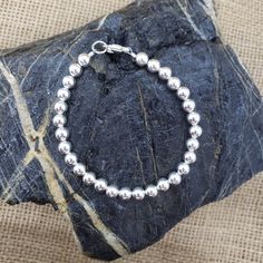 "Pretty! Classic everyday wear sterling silver beaded bracelet. All 6mm shiny round ball sterling silver beads. 🚩 6mm beads are considered MEDIUM - LARGE and may fit a little more snug. MEASURE WRIST: wrap string around wrist (not tight) and measure end to end. Suggest adding about 1/4\", depending on your own \"comfort\" fit length - whether a little room or loose fit. OR, measure your favorite link bracelet (end to end) and add a little extra length for these beads QUESTIONS? Send me a messag Classic Sterling Silver Bracelet With 8mm Beads, Sterling Silver Bracelet With 8mm Beads, Sterling Silver Beaded Bracelet With Spacer Beads, Classic Sterling Silver Bracelet With Silver Beads, Hand-strung Sterling Silver Bracelet With Round Beads, Sterling Silver Beaded Bracelets With 8mm Beads, Sterling Silver Bracelet With Spacer Beads, Classic Sterling Silver Beaded Bracelets With Round Beads, Classic Beaded Bracelets With Silver Beads