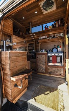 the interior of an old van with wood paneling and drawers on the door,