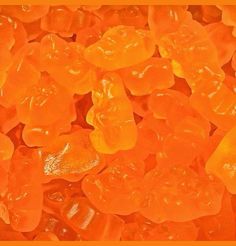 orange gummy bears sitting on top of each other