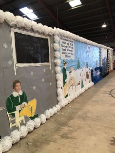 a decorated wall in the shape of a school bus with an image of a man sitting on a chair