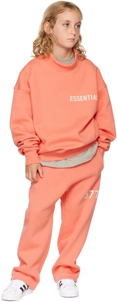 Relaxed-fit cotton-blend fleece lounge pants in pink. Text flocked at leg. · Mid-rise · Drawstring at elasticized waistband · Two-pocket styling · Rubberized logo patch at front · Rib knit gusset at dropped inseam · Hand wash Model measures 53 / 134.5 cm and wears size S. Please note that this item may not be shipped within the EU. Supplier color: Coral Size: child's height XXS: 36-41 / 91.5-104 cm XS: 41-44.5 / 104-113 cm S: 44.5-48.5 / 113-123 cm M: 48.5-53 / 123-134.5 cm L: 53-58 / 134.5-147. Casual Pink Cotton Sweatpants, Sporty Pink Sweatpants With Ribbed Waistband, Pink Cotton Sporty Sweatpants, Sporty Pink Bottoms With Ribbed Cuffs, Pink Fleece Sportswear Bottoms, Sporty Pink Sweatpants With Ribbed Cuffs, Pink Athleisure Sweatshirt For Leisure, Sporty Pink Pants With Ribbed Cuffs, Sporty Pink Fleece Bottoms