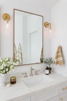 a bathroom sink with a large mirror above it