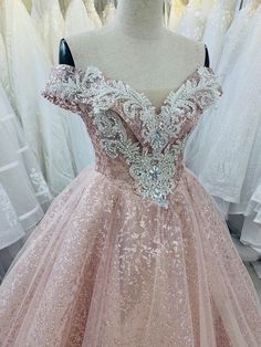 a pink ball gown with sequins on the shoulders